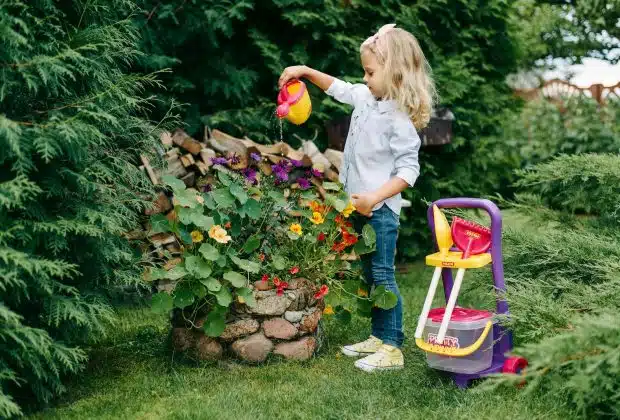 A Young Girl Watering a Plants